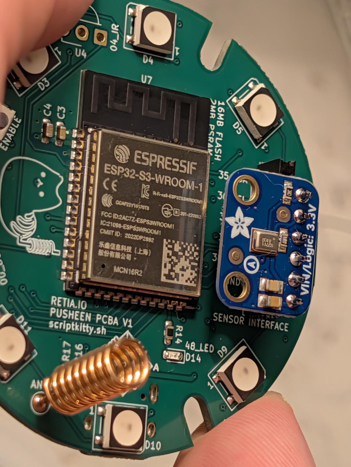 The Newsheen board with an Adafruit I2S microphone on the sensor header and a coil LoRa antenna on the antenna pad